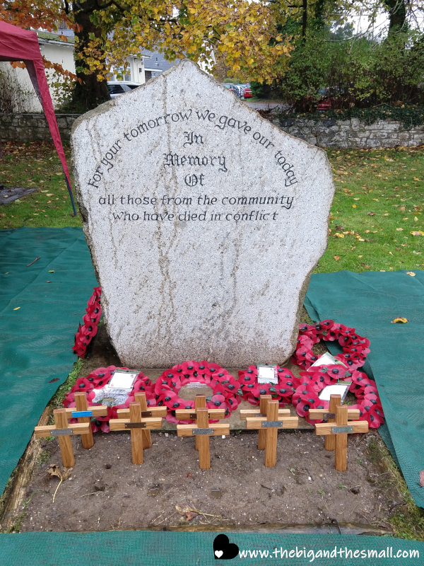 Stone Memorial with Poppy Wreaths.png
